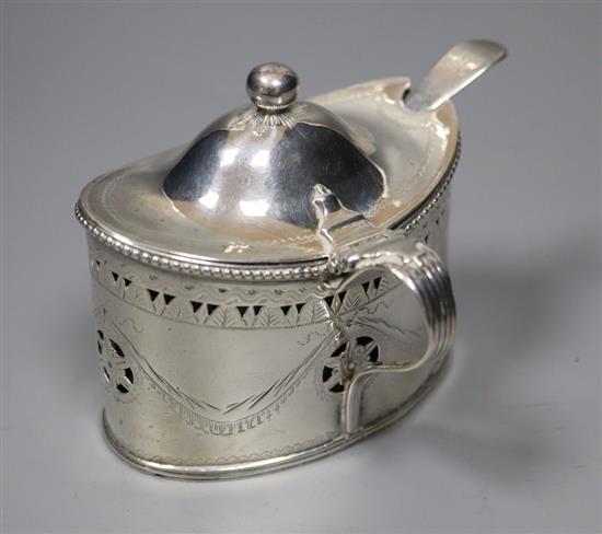 A George III engraved silver oval mustard by Robert Hennell I, London, 1786, 73mm, with later liner and spoon.